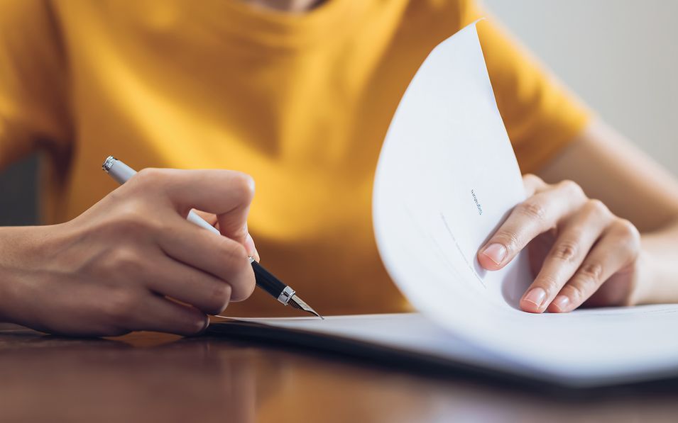 a woman singing paperwork
